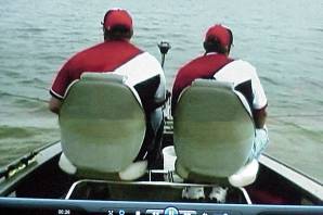 Two men in a boat on the water.
